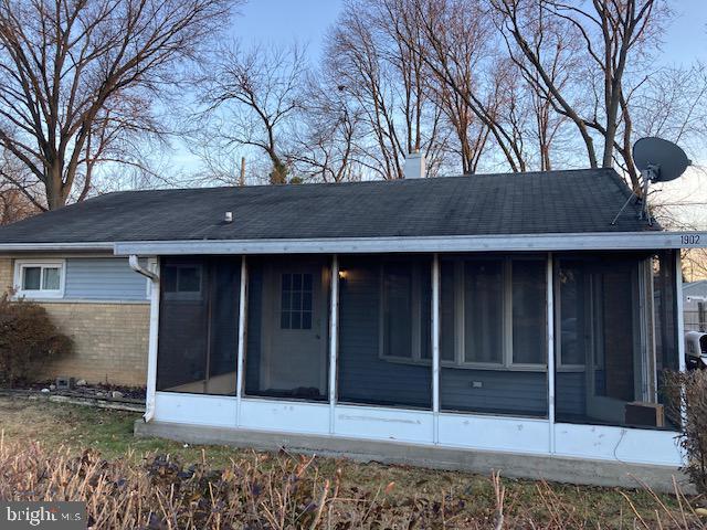 back of house featuring a sunroom