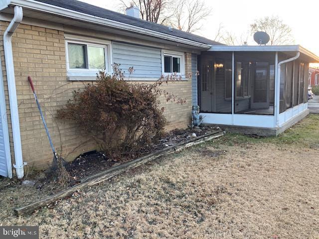 view of side of property featuring a sunroom