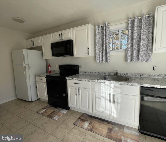 kitchen with light tile patterned flooring, sink, white cabinetry, and black appliances