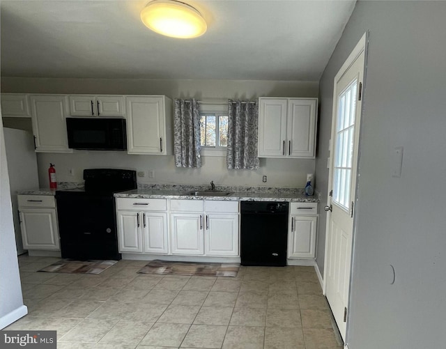 kitchen with white cabinetry, sink, black appliances, and light stone counters