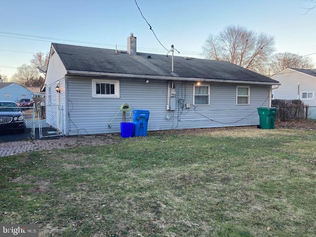 rear view of property featuring a yard