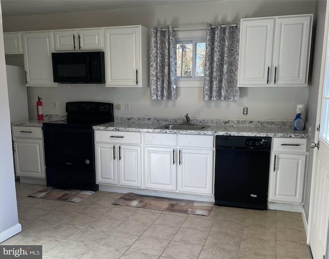 kitchen featuring light stone counters, sink, black appliances, white cabinets, and light tile patterned flooring