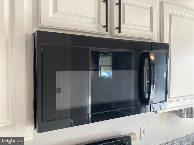 details featuring white cabinetry