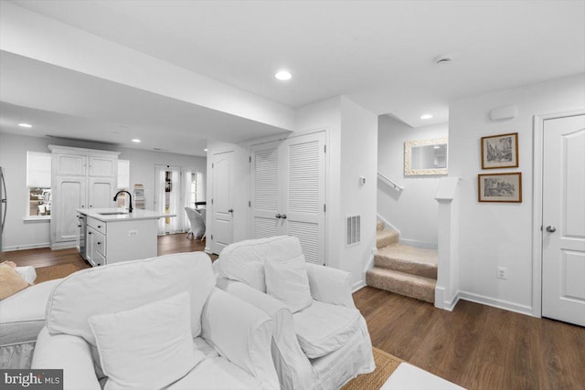 bedroom featuring sink and dark wood-type flooring