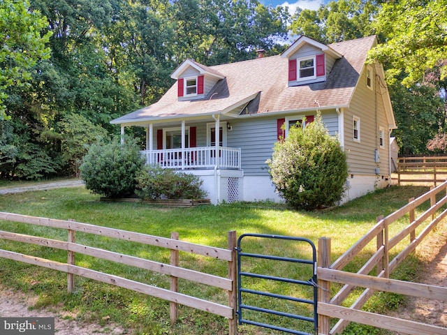 new england style home with a porch and a front lawn