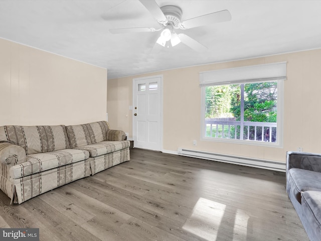 living room with hardwood / wood-style flooring, baseboard heating, and ceiling fan