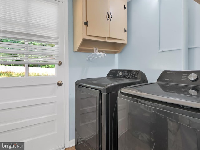 laundry area with cabinets and washing machine and clothes dryer