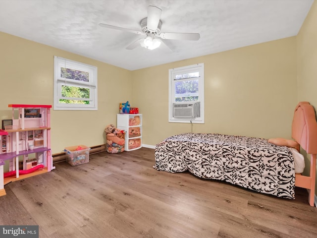 bedroom with wood-type flooring, a baseboard heating unit, ceiling fan, and cooling unit