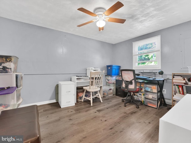 home office featuring ceiling fan and dark hardwood / wood-style floors