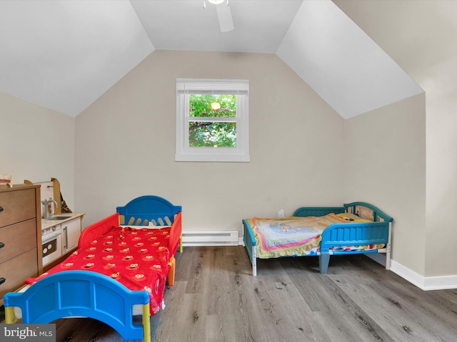 bedroom featuring a baseboard heating unit, sink, vaulted ceiling, ceiling fan, and wood-type flooring