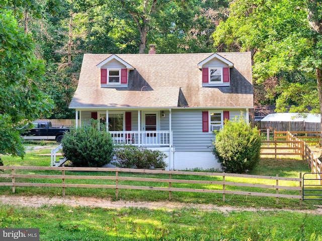 cape cod home featuring covered porch