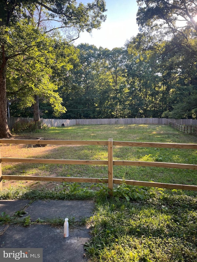 view of gate with a yard