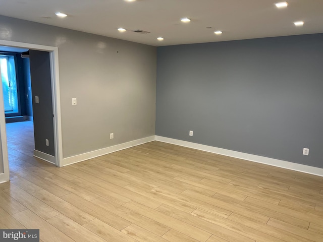 unfurnished room with light hardwood / wood-style floors