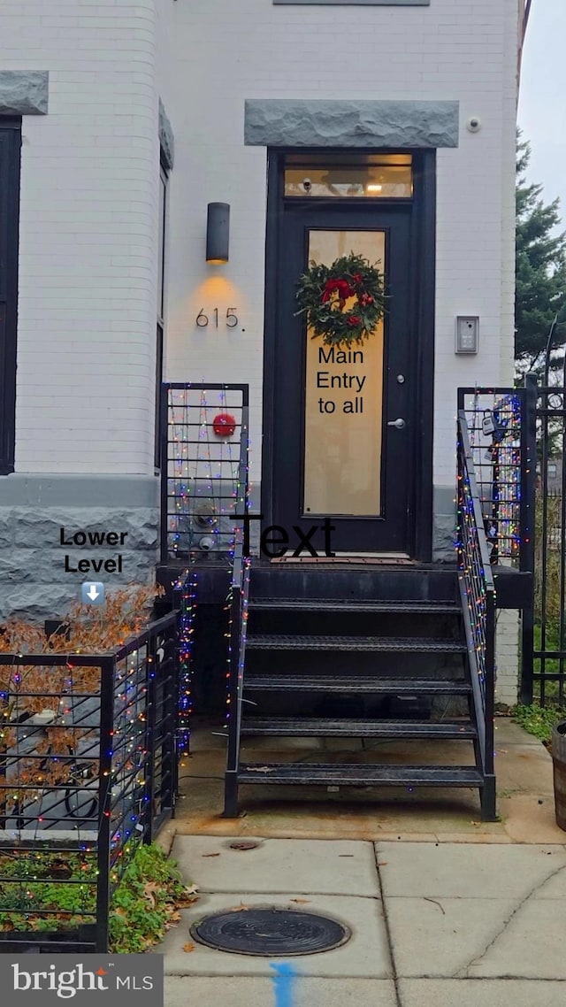 doorway to property featuring brick siding