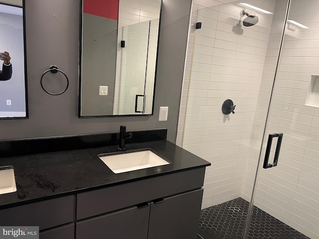 bathroom featuring a shower stall and vanity