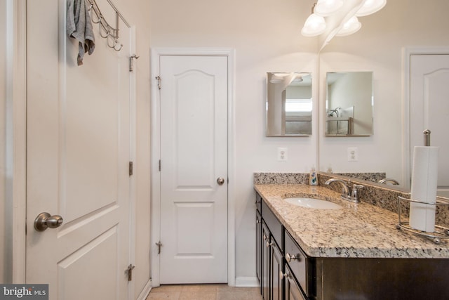 bathroom featuring tile patterned flooring and vanity