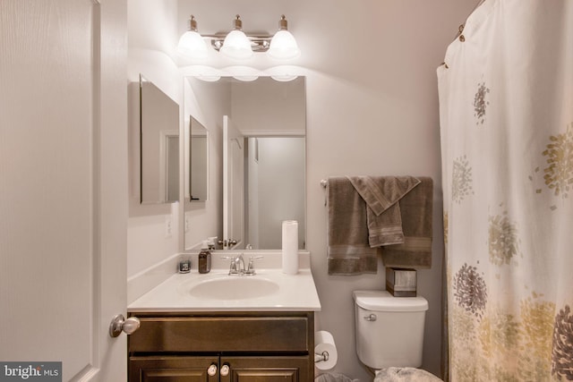 bathroom featuring vanity and toilet