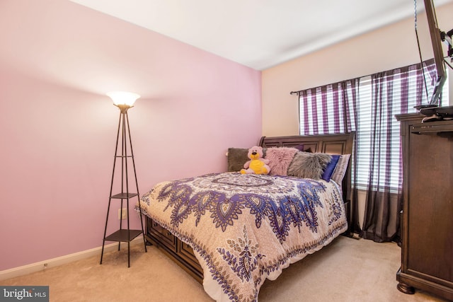 bedroom featuring light carpet