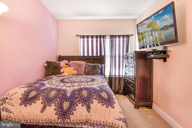 bedroom featuring light colored carpet