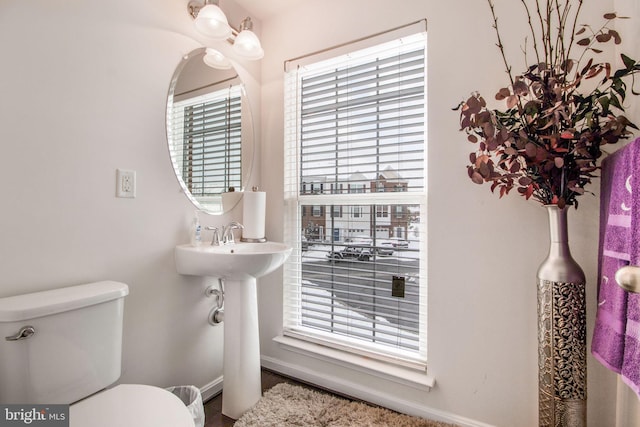 bathroom with plenty of natural light and toilet