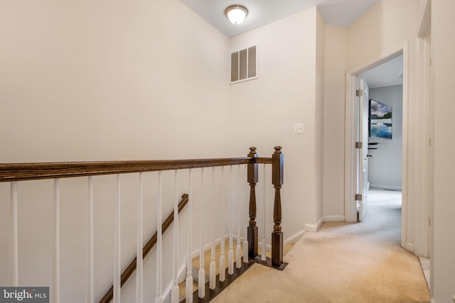 corridor with light colored carpet