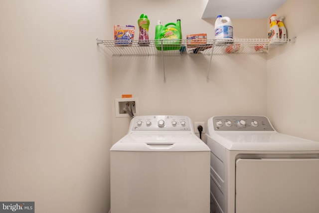 clothes washing area featuring washing machine and clothes dryer