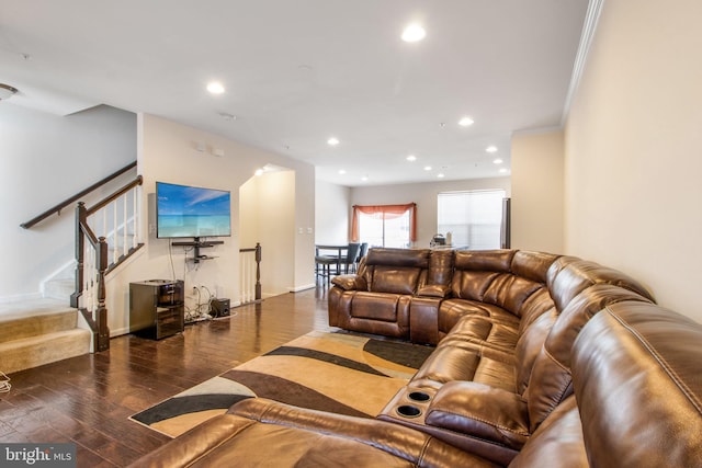 living room featuring dark wood-type flooring and ornamental molding