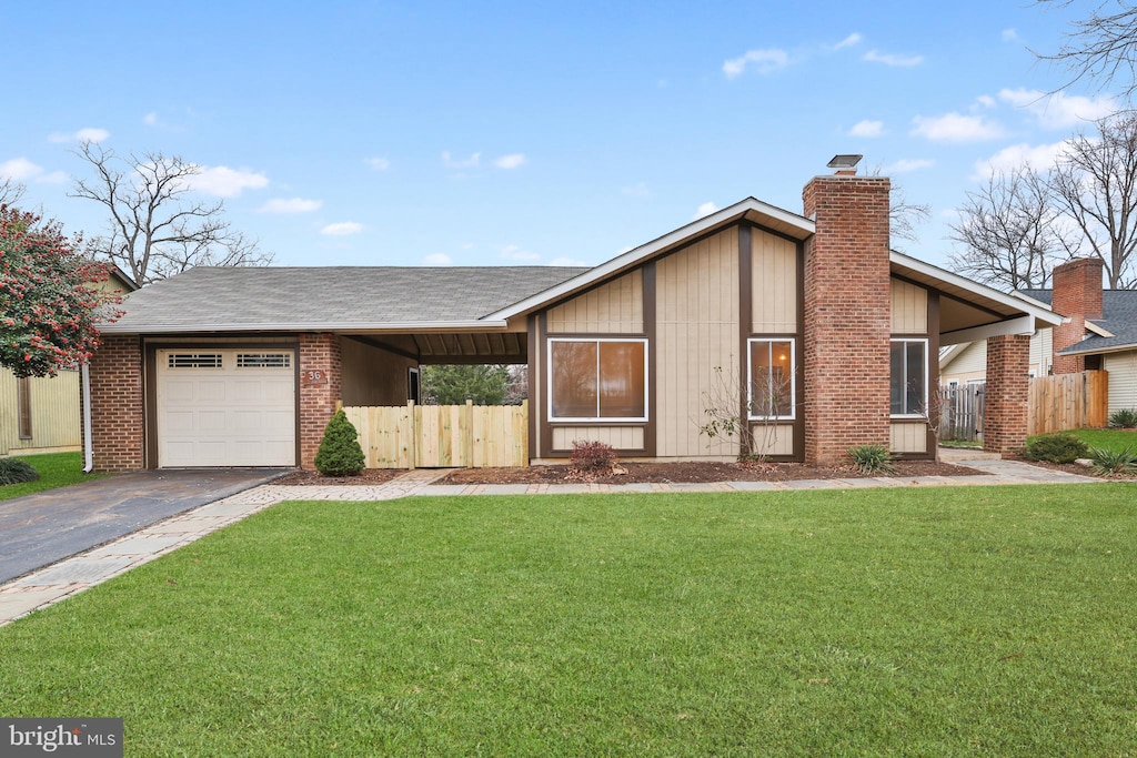 view of front of home with a front yard and a garage