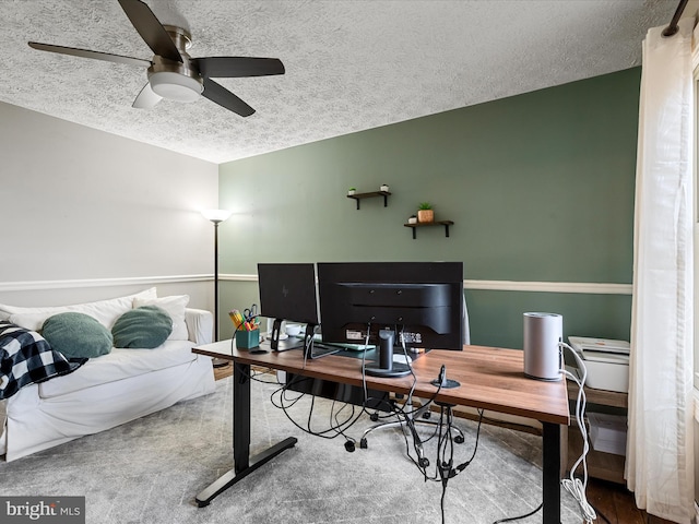 office area with ceiling fan and a textured ceiling