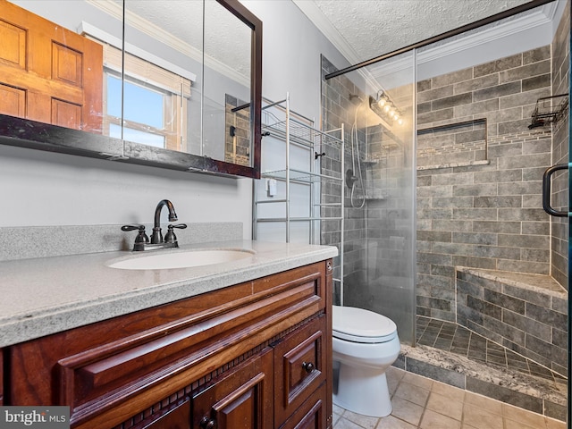 bathroom featuring tile patterned floors, a textured ceiling, toilet, vanity, and ornamental molding