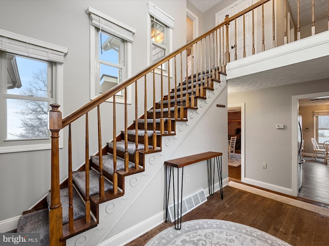 staircase with hardwood / wood-style flooring