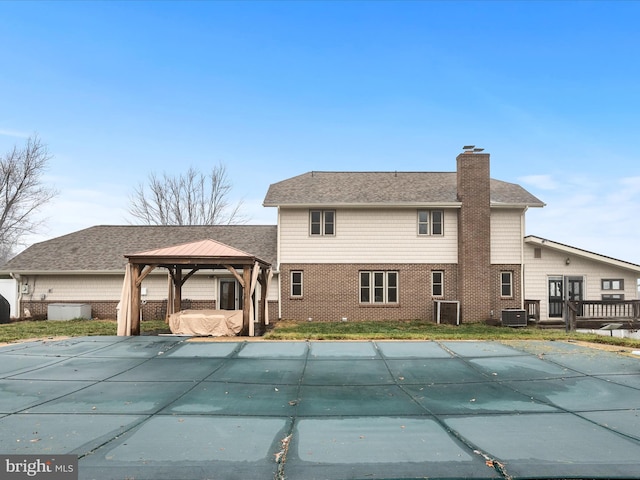 back of house featuring a gazebo, cooling unit, and a covered pool