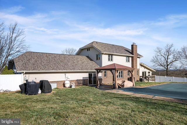 back of property with a gazebo, a yard, a patio, and a covered pool