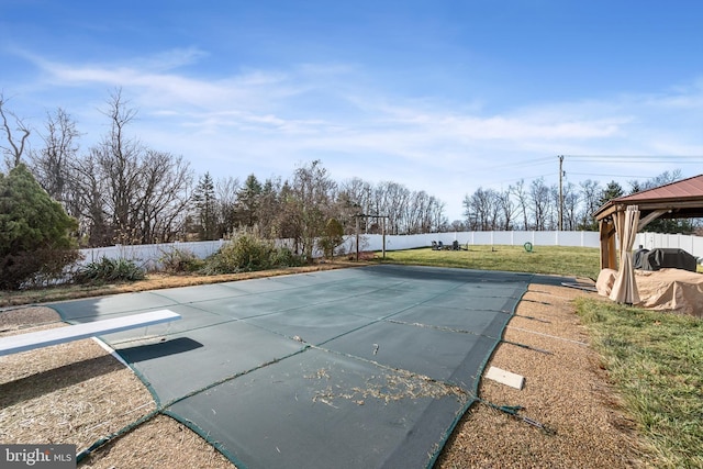 view of pool featuring a gazebo, a diving board, and a yard