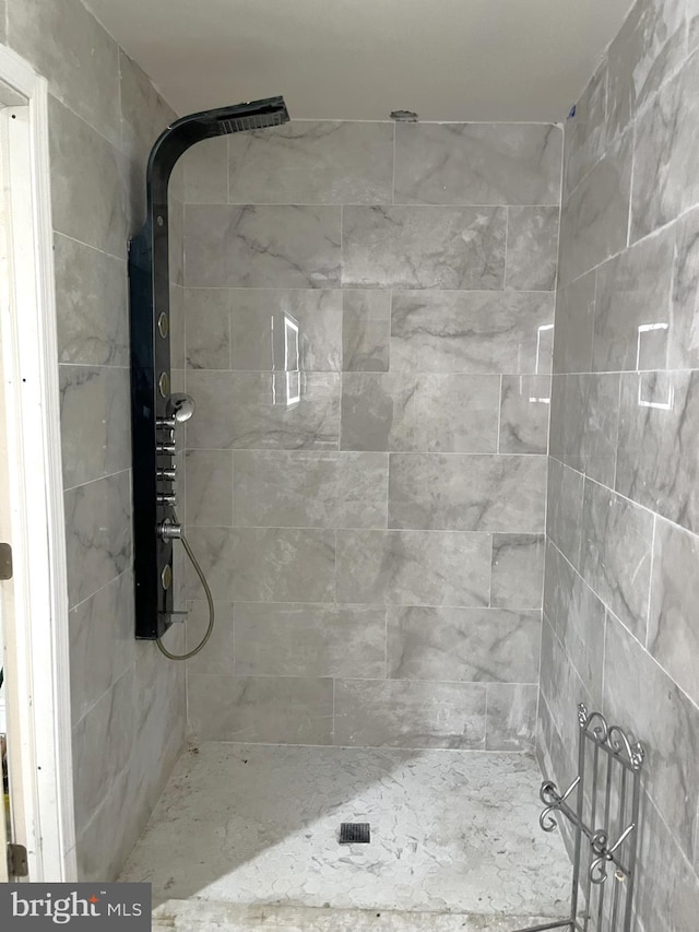 bathroom with tiled shower