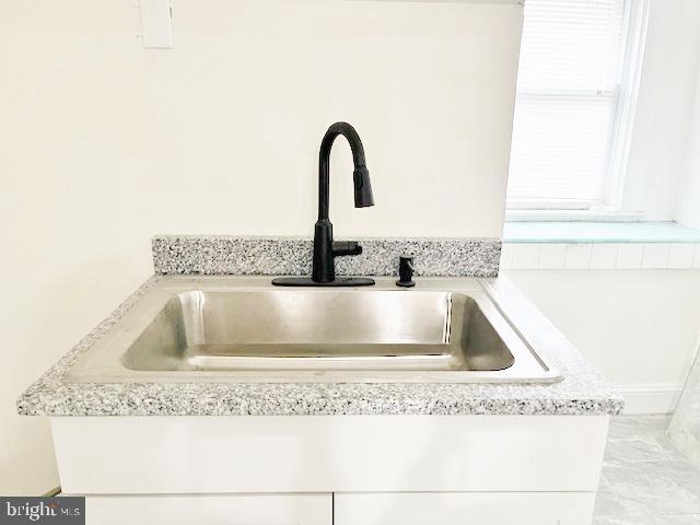 room details with white cabinets and sink