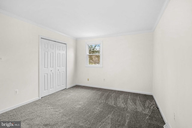 unfurnished bedroom with carpet floors, a closet, and crown molding