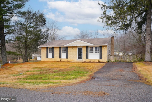 ranch-style home with a front lawn