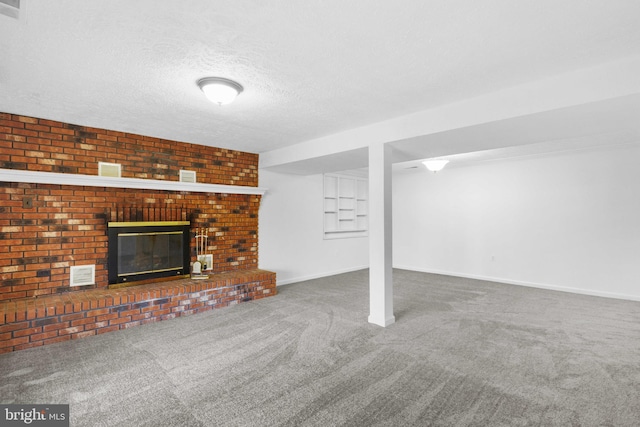 basement with carpet, a textured ceiling, and a fireplace