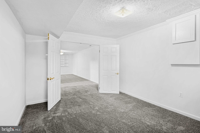 basement featuring dark colored carpet and a textured ceiling