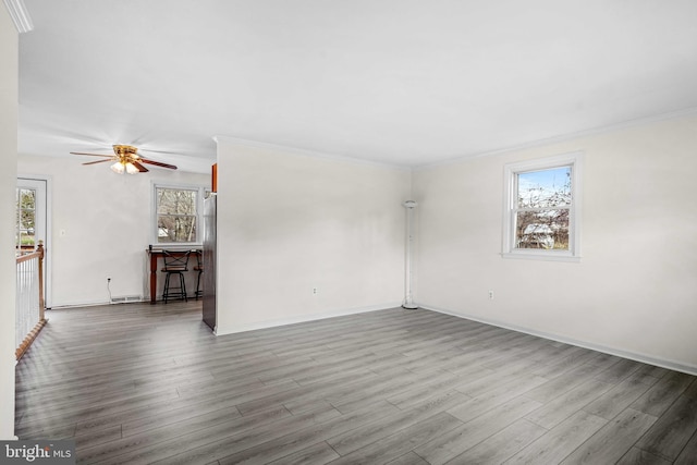 spare room featuring ceiling fan, ornamental molding, and hardwood / wood-style flooring