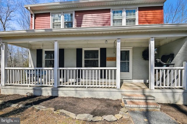 view of front of house with brick siding and covered porch