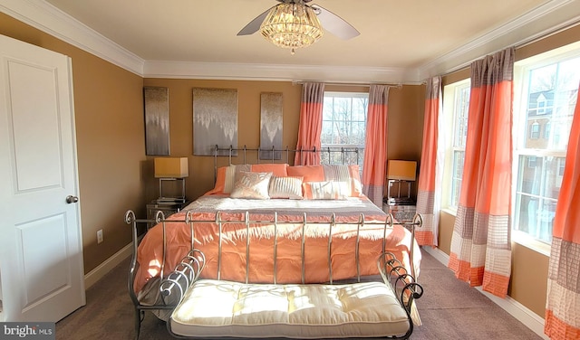 bedroom with carpet floors, ceiling fan, and crown molding