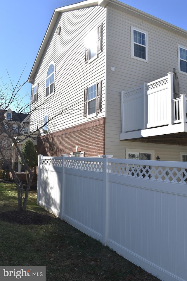 view of side of property with a balcony