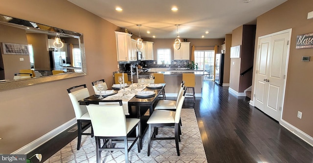 dining space with hardwood / wood-style flooring