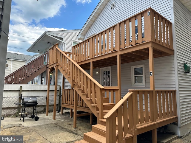 wooden terrace with a grill