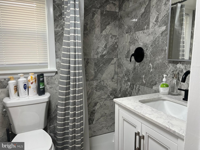 bathroom featuring a shower with curtain, vanity, tile walls, and toilet