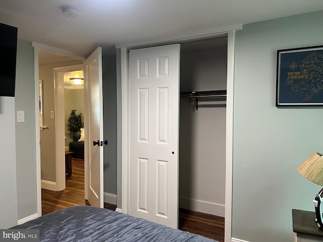 bedroom featuring dark hardwood / wood-style flooring and a closet