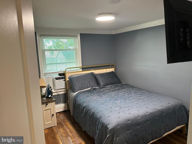 bedroom featuring cooling unit, dark hardwood / wood-style floors, and ornamental molding