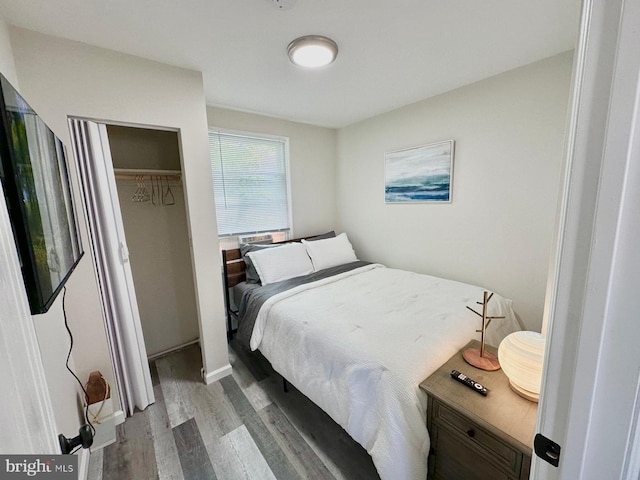 bedroom featuring a closet and light wood-type flooring